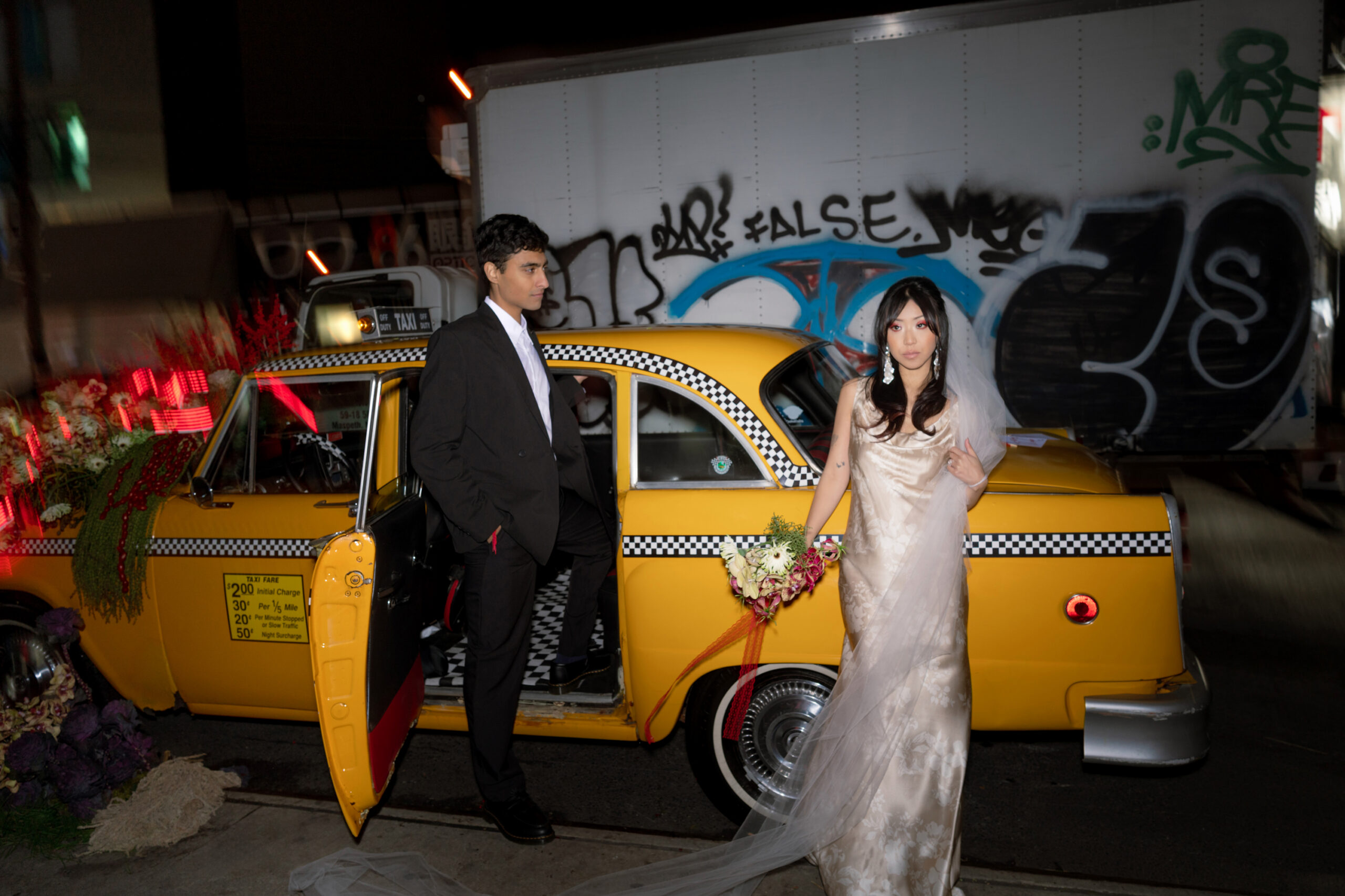 Brooklyn editorial engagement session in Chinatown with high fashion couple and floral taxi design